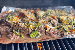 Buffalo Sirloin Tip Shaved Cheese Steak on the grill.