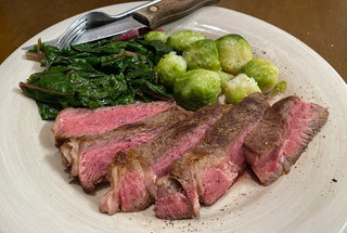 Medium rare Grass-Fed Beef Ribeye Steak and vegetables.