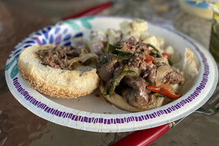 Buffalo Sirloin Tip Shaved Steak sandwich with grilled onions and peppers.