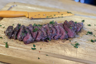 Medium-rare Buffalo New York Strip Steak with herbs.