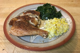 Naturally-Raised Chicken Legs with corn and spinach.